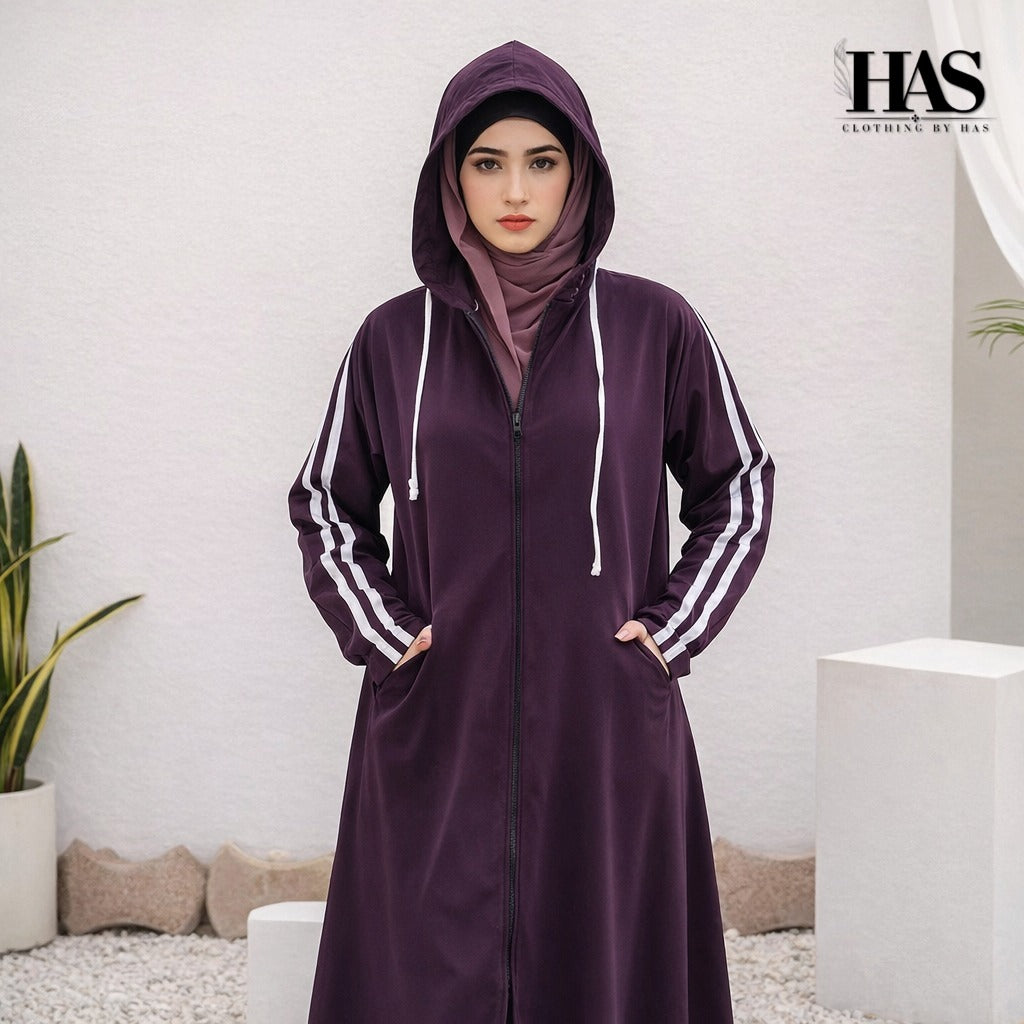 A woman is wearing a modest, sporty-style long outer garment in a deep  color.